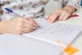 Close up of a girl writing math exercise at home. Selected focus Royalty Free Stock Photo