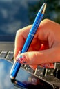 Close up of girls hand with notebook, pen and mobile phone Royalty Free Stock Photo