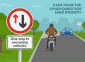 Close-up of give way to oncoming vehicles sign. Back view of a stopped motorcycle rider. Royalty Free Stock Photo