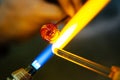 Close-up of glass bead melting in gas-burner fire