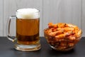 Close up of a glass of beer and shrimp in a glass bowl on a dark stone background. Horizontal photo, macro, selective focus. Royalty Free Stock Photo