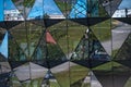 Close-up of the glass-clad facade of a modern building covered in reflective triangles plate glass Royalty Free Stock Photo