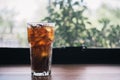 Close-up glass of cola with ice at side the window Royalty Free Stock Photo