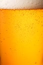 Close-up glass of cold beer with foam as texture and background, post-processed, generative ai Royalty Free Stock Photo