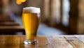 Close-up of glass of cold beer glass with foam on table. Cool beverage. Alcoholic drink