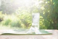 Close up glass of cold water with ice on table with blur garden Royalty Free Stock Photo