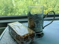 Close-up of a glass with a cup holder on the table of a Russian Railways train car. Packaged pack of cookies lies next to the Royalty Free Stock Photo