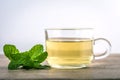 Close up a glass cup of mint tea with green fresh peppermint lea Royalty Free Stock Photo