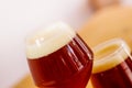 Close up of glass of dark beer with foam on a wooden table Royalty Free Stock Photo