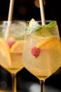 Close-up of glass of drink with raspberry lemon and mint and with drinking straw. Royalty Free Stock Photo