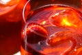 Close up of glass edge of red cocktail with strawberry and  ice cubes Royalty Free Stock Photo