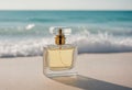 Close up of glass fresh perfume bottle standing on sand. Ocean in background. Selective perfumery and luxury fragrance Royalty Free Stock Photo