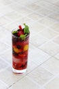 close up of a glass full of colorful fruits and berries and mint served with ice and soda as summer refreshment Royalty Free Stock Photo