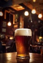 Close up of a glass of golden beer with blurred background on a table with reflection Royalty Free Stock Photo