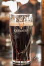 Close up of a glass of Guinness stout beer on a bar counter in Dublin Ireland