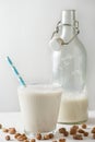 Close-up of glass of horchata with blue straw and bottle on table Royalty Free Stock Photo