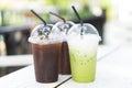 Close up glass of ice matcha green tea and ice coffee on wood table, selective focus Royalty Free Stock Photo