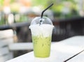 Close up glass of ice matcha green tea on wood table, selective focus Royalty Free Stock Photo