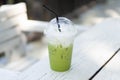 Close up glass of ice matcha green tea on wood table, selective focus Royalty Free Stock Photo