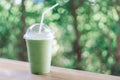 Close up glass of ice matcha green tea on wood table, selective focus Royalty Free Stock Photo