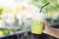 Close up glass of ice matcha green tea on wood table, selective focus Royalty Free Stock Photo