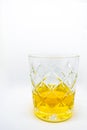 A close-up of a glass of wiskey isolated on a white background