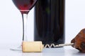 Close up of glass of red wine, bottle and corkscrew Royalty Free Stock Photo