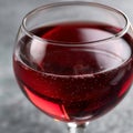 Close-up of a glass of red wine with bubbles on the surface. Royalty Free Stock Photo