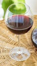 Close Up of Glass of Red Wine and Decanter on Rattan Wicker Table in Garden Terrace of Villa or Mansion. Authentic Lifestyle Image Royalty Free Stock Photo