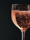 Close-up of a glass of sparkling wine with bubbles against a dark background. Royalty Free Stock Photo