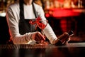 Close-up of glass with splashing cocktail decorated with flower on bar counter Royalty Free Stock Photo