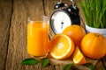 Close-up of Glass squeezed orange juice and fresh fruits ripe cut half, slice with green leaves on old wood vintage table. Royalty Free Stock Photo