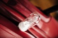 Close-up of glass standard tungsten wolfram filament lamp bulb red color Royalty Free Stock Photo