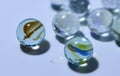 Close-up of glass transparent balls with unusual multi-colored decorations inside with a soft blurred background.