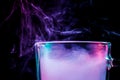 A glass with colorful smoke