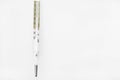 Close up of glass tube and mercury thermometers on white background