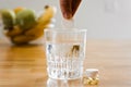 Close up glass with water and sparkling pill. Magnesium anti-stress, painkiller or orange drink Royalty Free Stock Photo