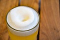 Glass with wheat unfiltered beer and lush white beer foam Royalty Free Stock Photo