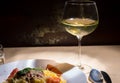 Close up of glass with wine near spaghetti pasta in white plate Royalty Free Stock Photo