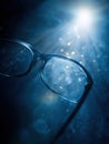 Close-up of Glasses With Blue Lighting and Sparkling Particles Creating an Artistic Atmosphere in a Dimly Lit Setting Royalty Free Stock Photo