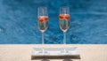 Close up of glasses with champagne or prosecco with raspberry