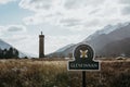 Close up of Glenfinnan sign, Glenfinnan Monument on the background, Scotland, UK.
