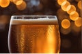 Close-up of a glistening droplet sliding down the side of a chilled amber-tinted craft beer glass