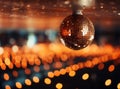 Close-up of a glittering disco ball reflecting warm golden lights in a dark room. Royalty Free Stock Photo