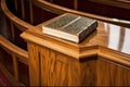 close-up of a glossy wooden pulpit with bible