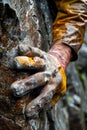 Close Up of a Gloved Hand Gripping a Wet Rock Surface During an Outdoor Climbing Expedition