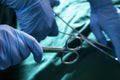 Close-up of gloved hands holding the surgical scissors and working, operating room, hospital Royalty Free Stock Photo