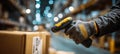 Close-up of Gloved Hands Scanning Box Label in Warehouse Setting Royalty Free Stock Photo