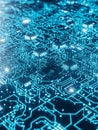 Close-up of a glowing blue circuit board with intricate pathways and microchips electronics technology Royalty Free Stock Photo