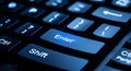 Close-up of a glowing blue Enter key on a dark computer keyboard technology digital Royalty Free Stock Photo